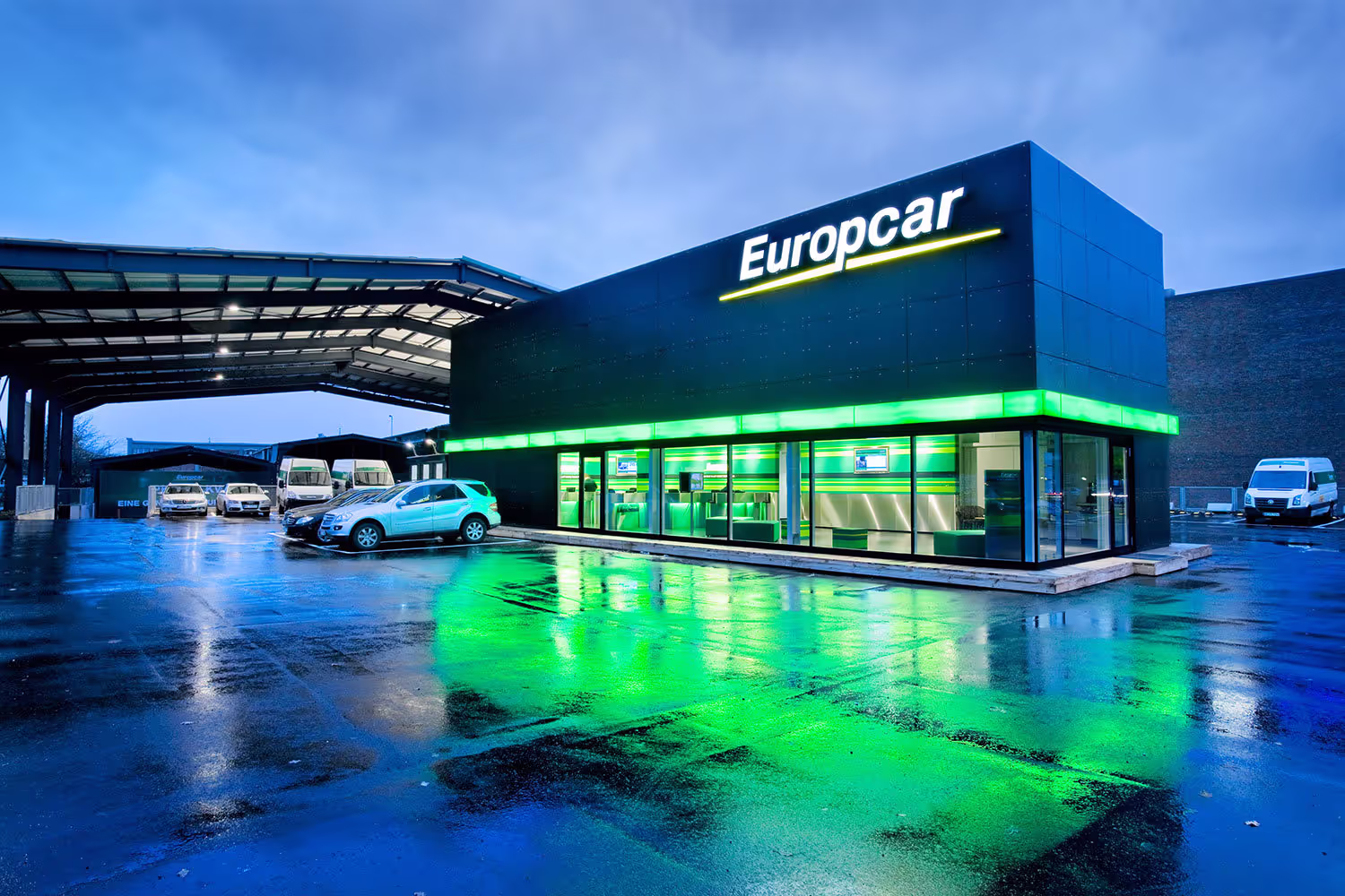 Building with Europcar logo with cars parked next to it.